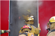 Fire Fighters at a Location in Smoke