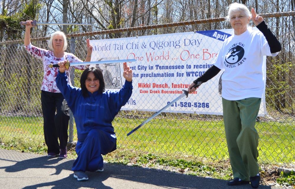 Barbara Sandlin and Susan Van Aalten demonstrate Tai Chi sword use.