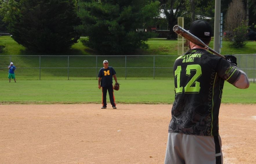 Men play in a softball tournament.