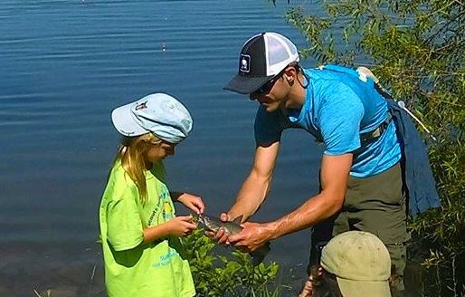 A girl catches a fish.