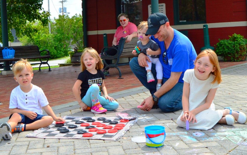 A family plays games during Family Fun Frolic.