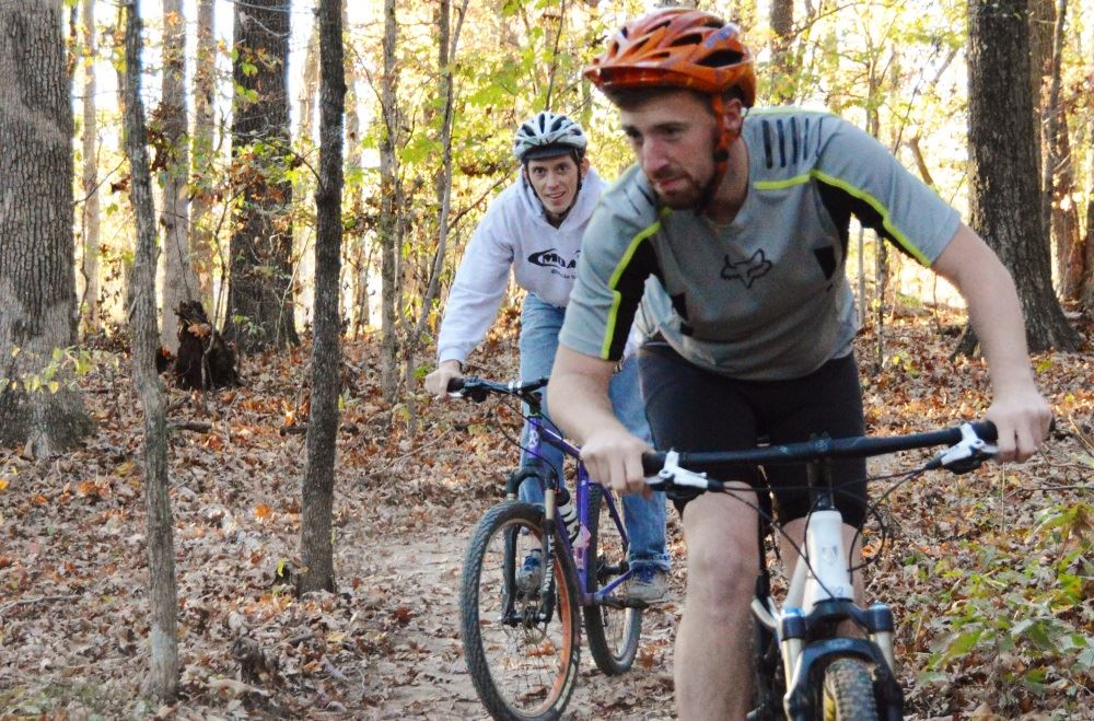 Cyclists ride on Cane Creek Park's mountain bike trail.