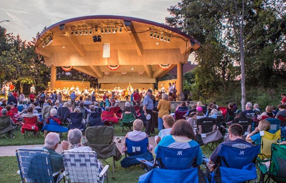 People gather at the Dogwood Park performance pavilion for a concert.