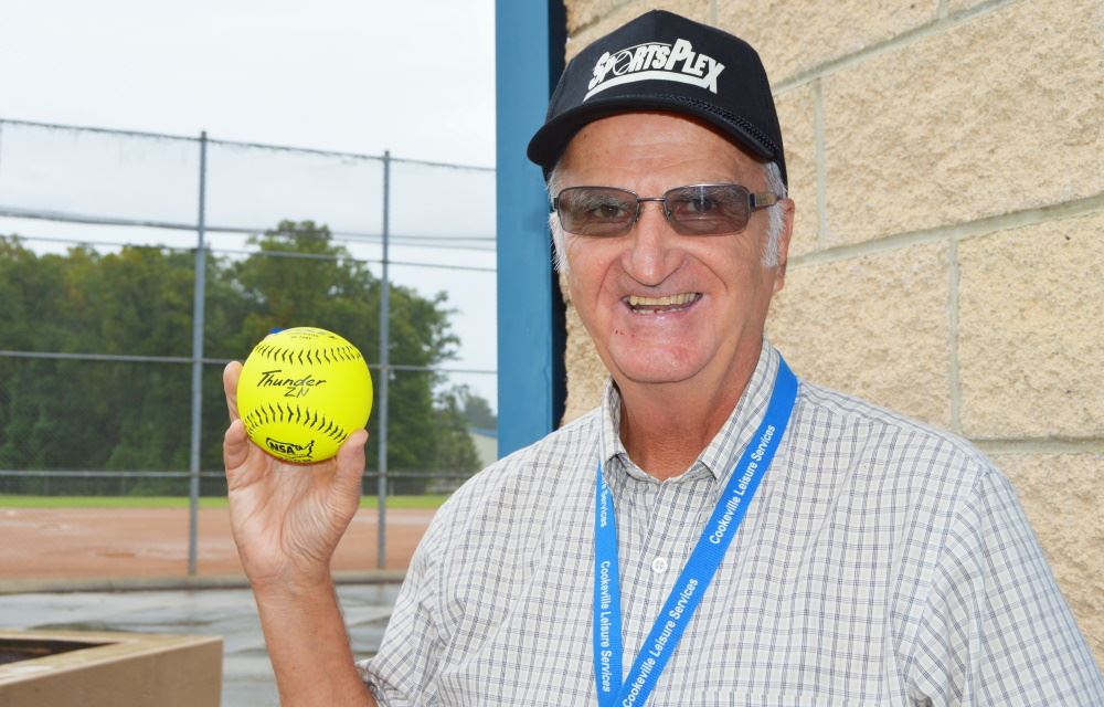 Jim Crea holds a softball at Cane Creek SportsPlex