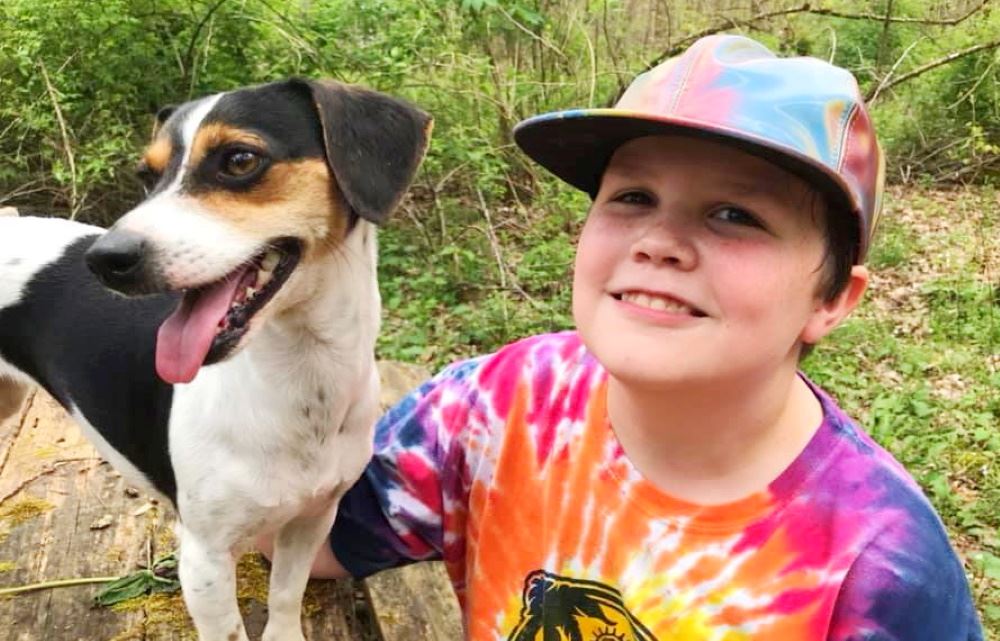 A boy poses with his dog for Virtual Dogapalooza.