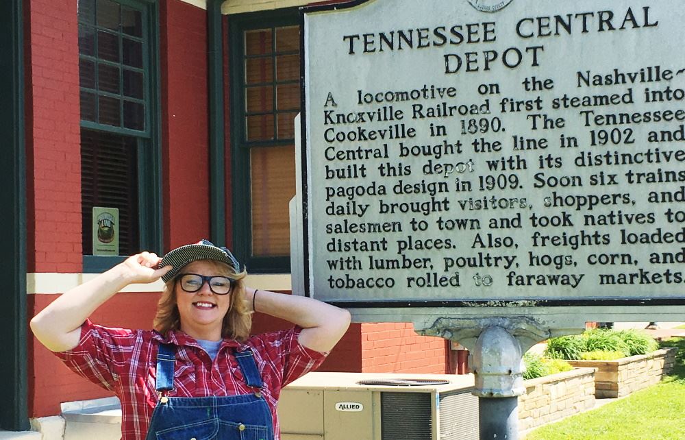 Engineer Ashley stands next to the Cookeville Depot historical marker.