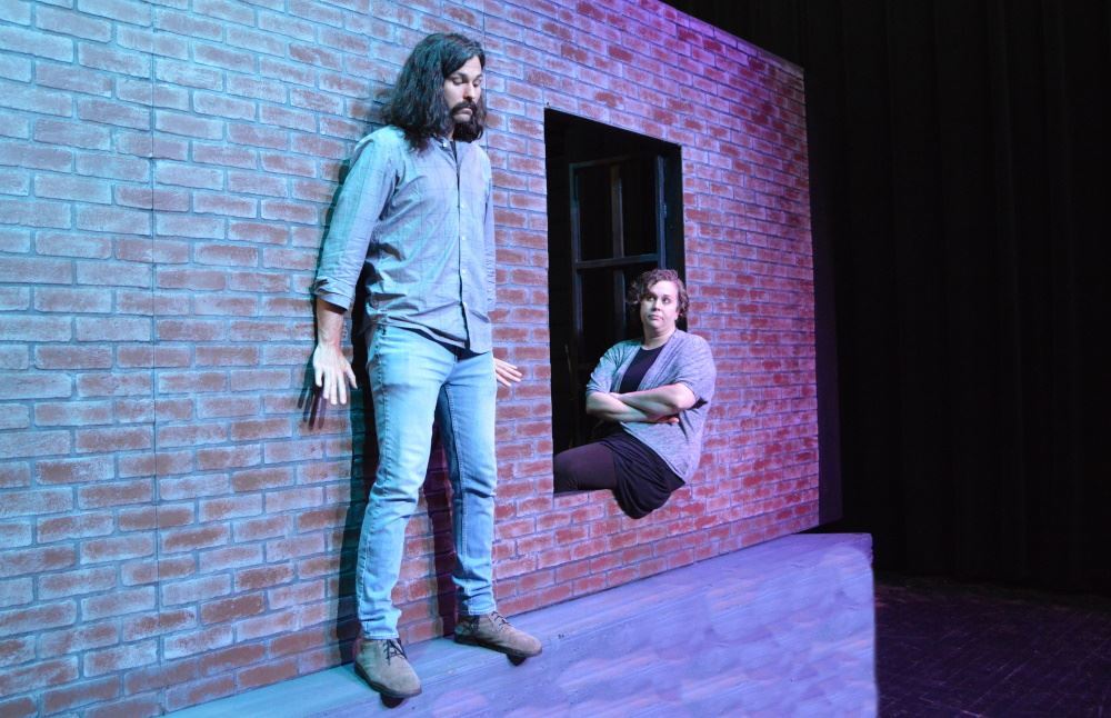 A man stands on the ledge of a building in CPAC's 