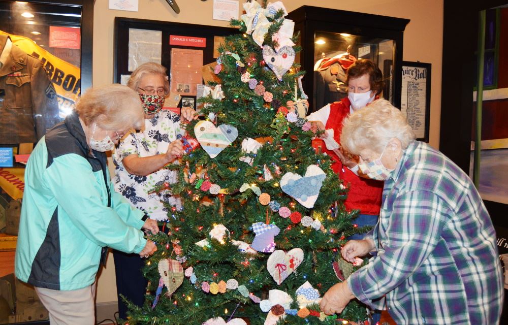 Button Society members decorate their tree in the Christmas Forest at the Cookeville History Museum.
