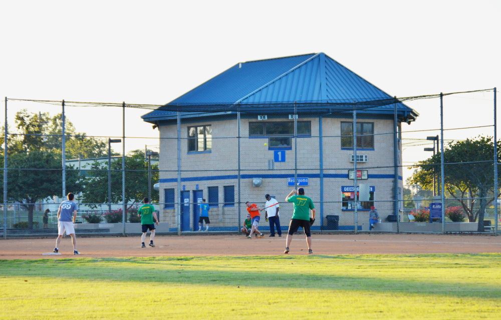 Softball players play a game at Cane Creek SportsPlex
