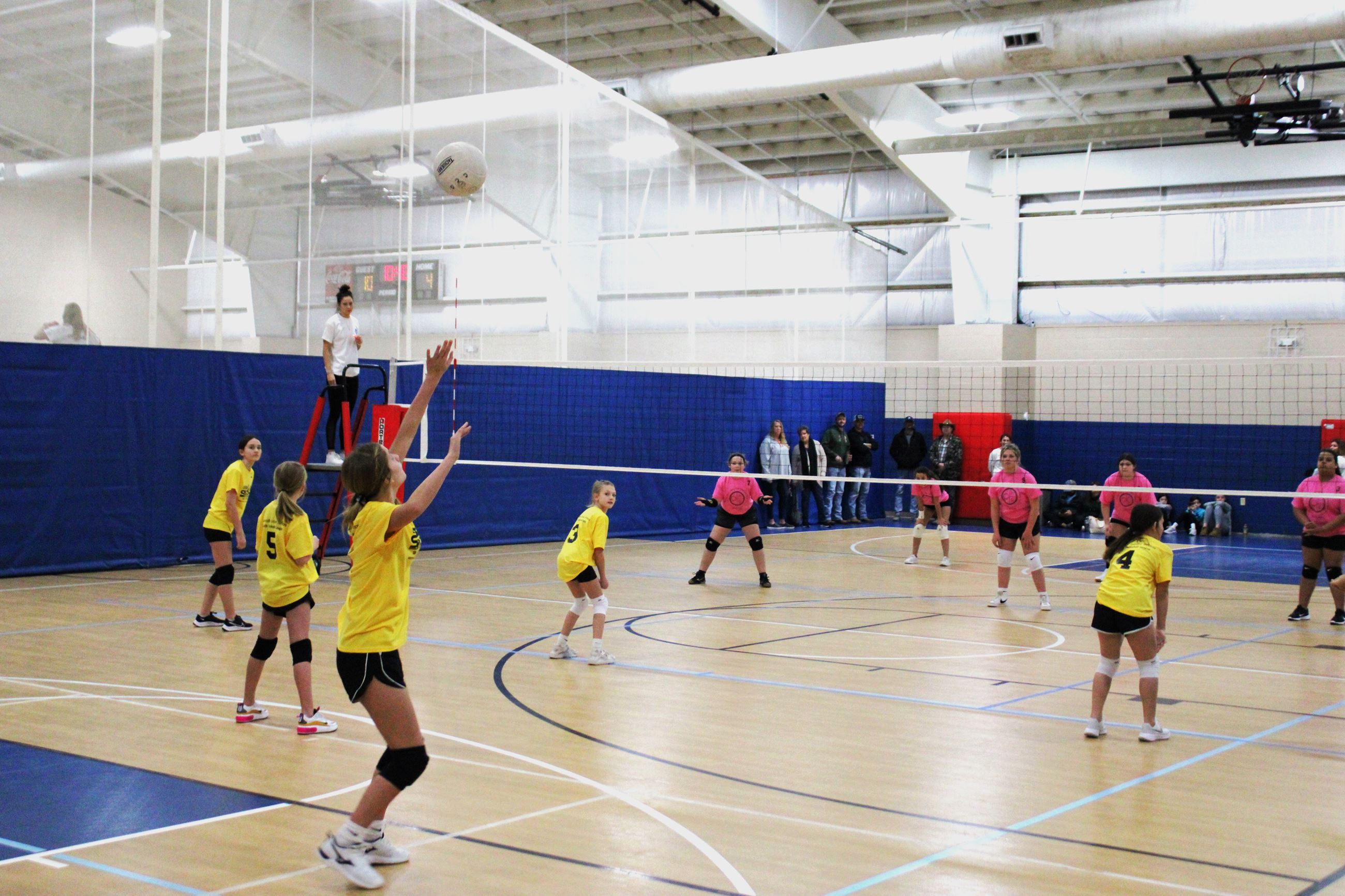 Teens playing volleyball in the Cane Creek Gymnasium