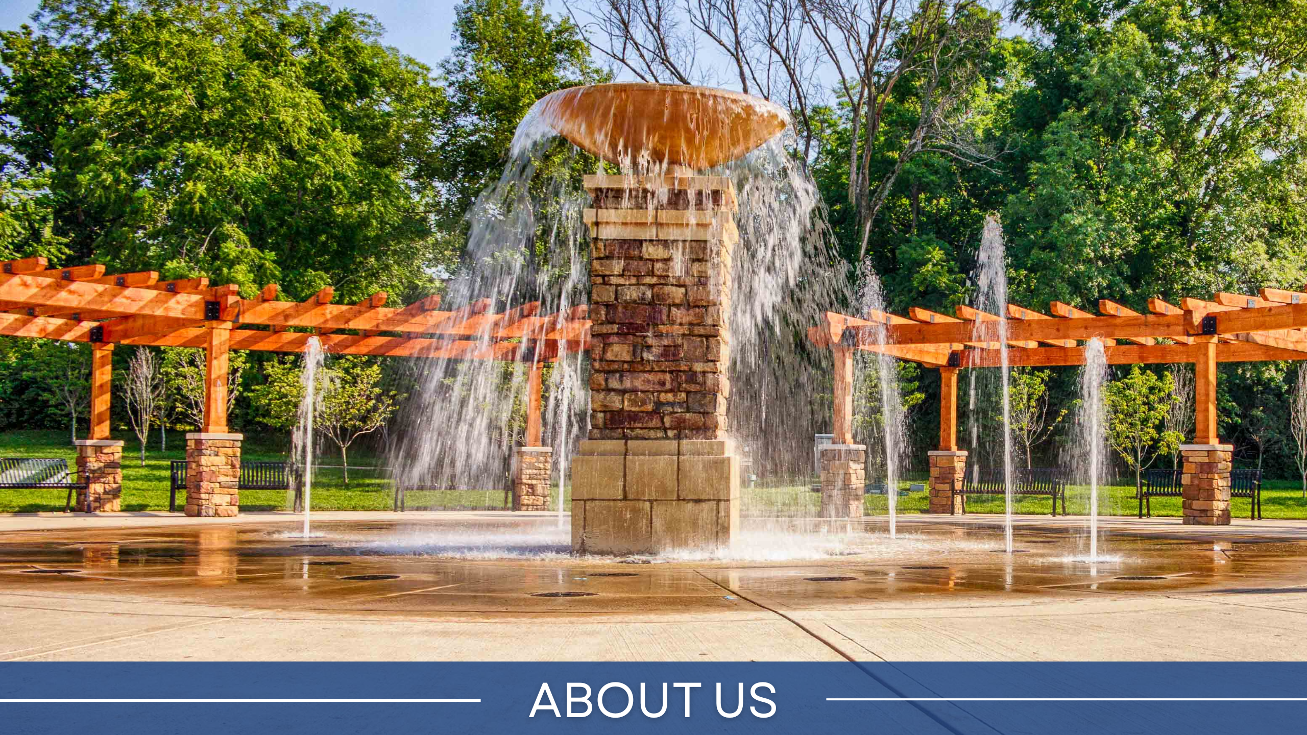 image of the dogwood park fountain with the words "about us" on the bottom