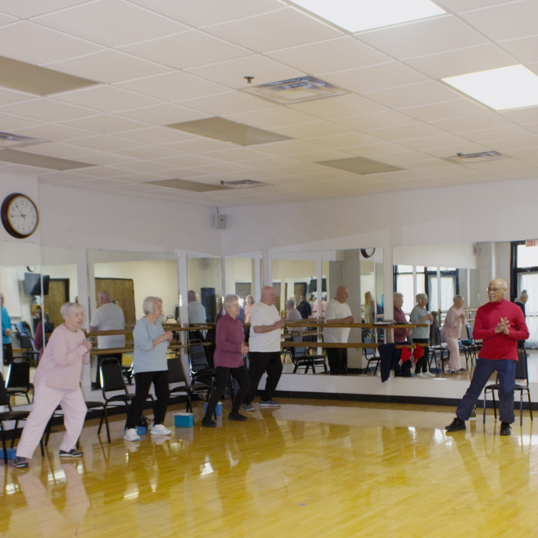 intermediate balance class - people using chairs to improve balance during class 